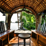Traditional Kerala houseboat interior overlooking serene backwaters in Cochin