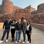 Group of tourists posing at the historic Agra Fort, a UNESCO World Heritage Site in India.