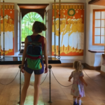 Visitors exploring traditional Kerala murals inside a heritage palace