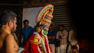 Kathakali dancer in traditional costume preparing for a performance in Kerala
