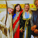 Tourists posing in traditional Bollywood costumes during a Mumbai film studio tour experience