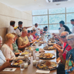 Tour group enjoying a traditional Indian thali lunch at a restaurant during a guided Mumbai sightseeing tour