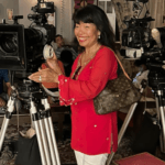 Tourist interacting with professional movie cameras at a Bollywood film studio in Mumbai