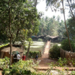 Entrance to a traditional Goan spice plantation surrounded by tropical greenery