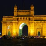 Gateway of India illuminated at night with visitors and city lights Mumbai