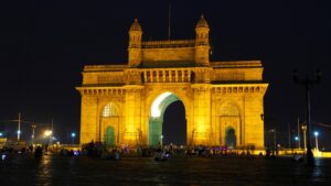 Gateway of India illuminated at night with visitors and city lights Mumbai