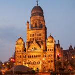 Brihanmumbai Municipal Corporation building illuminated at night with traffic light trails in Mumbai