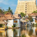 Traditional Kerala temple and village houses reflected in water at Kumbalangi near Kochi