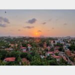 Sunset view of Mangalore city with palm-lined neighborhoods and coastal skyline